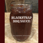 Mason jar full of barbecue sauce sitting on tile counter with text overlay - Blackstrap BBQ Sauce The Homemade Revelation