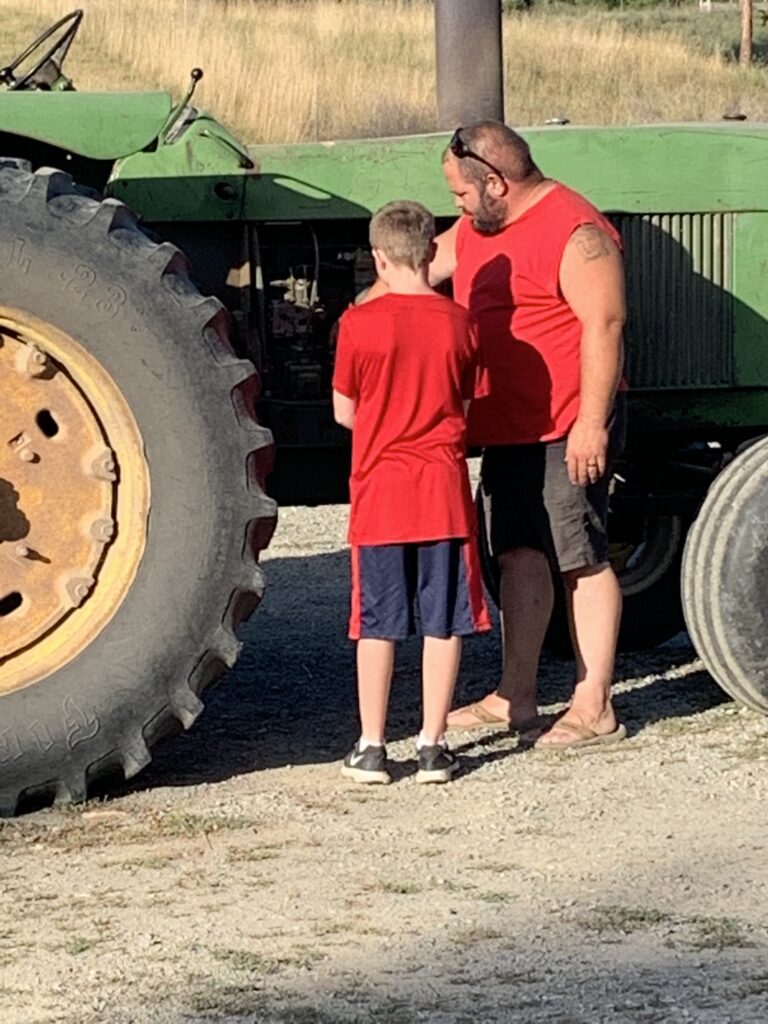 father and son with tractor